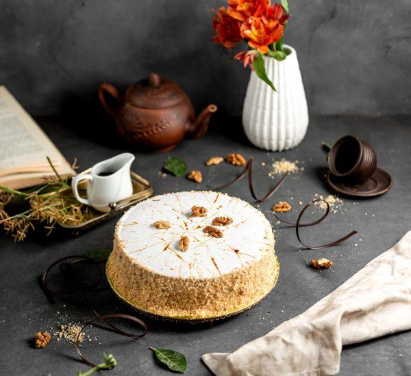 white glazed cake decorated with cake crumbles and walnuts white glazed cake decorated with cake crumbles and walnuts